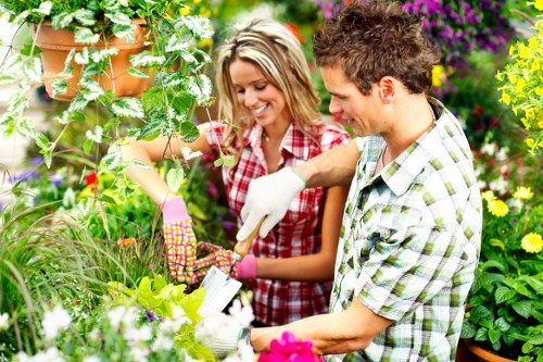 Gardeners wearing PPE and performing safe landscaping work